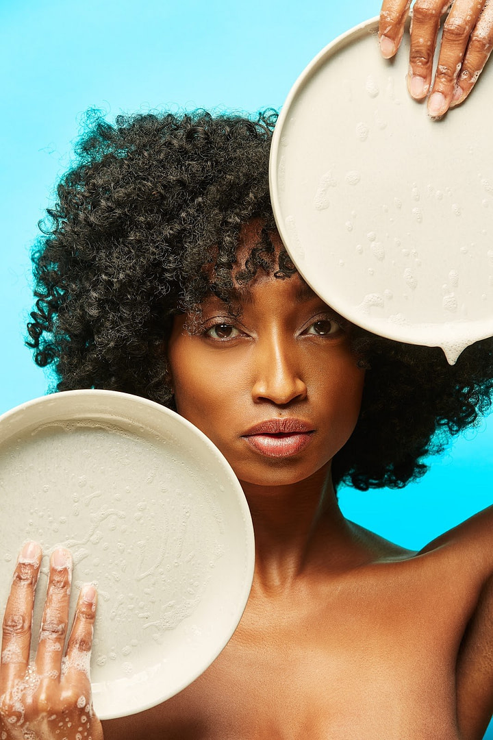 Woman Holding Up Two Soapy Plates