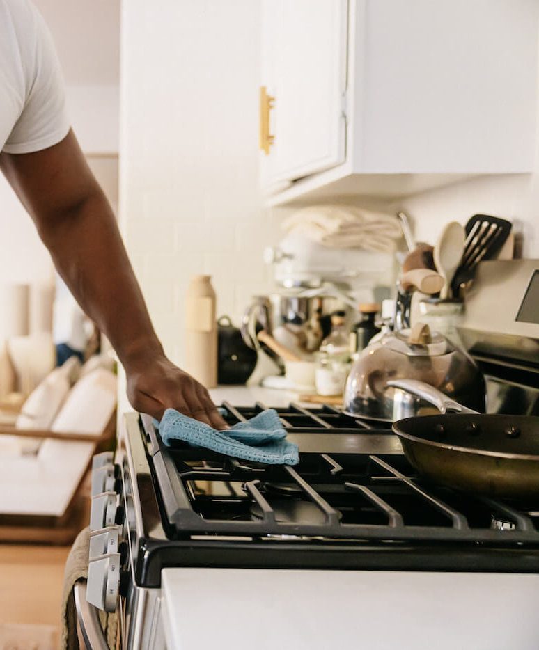 Man cleaning stove