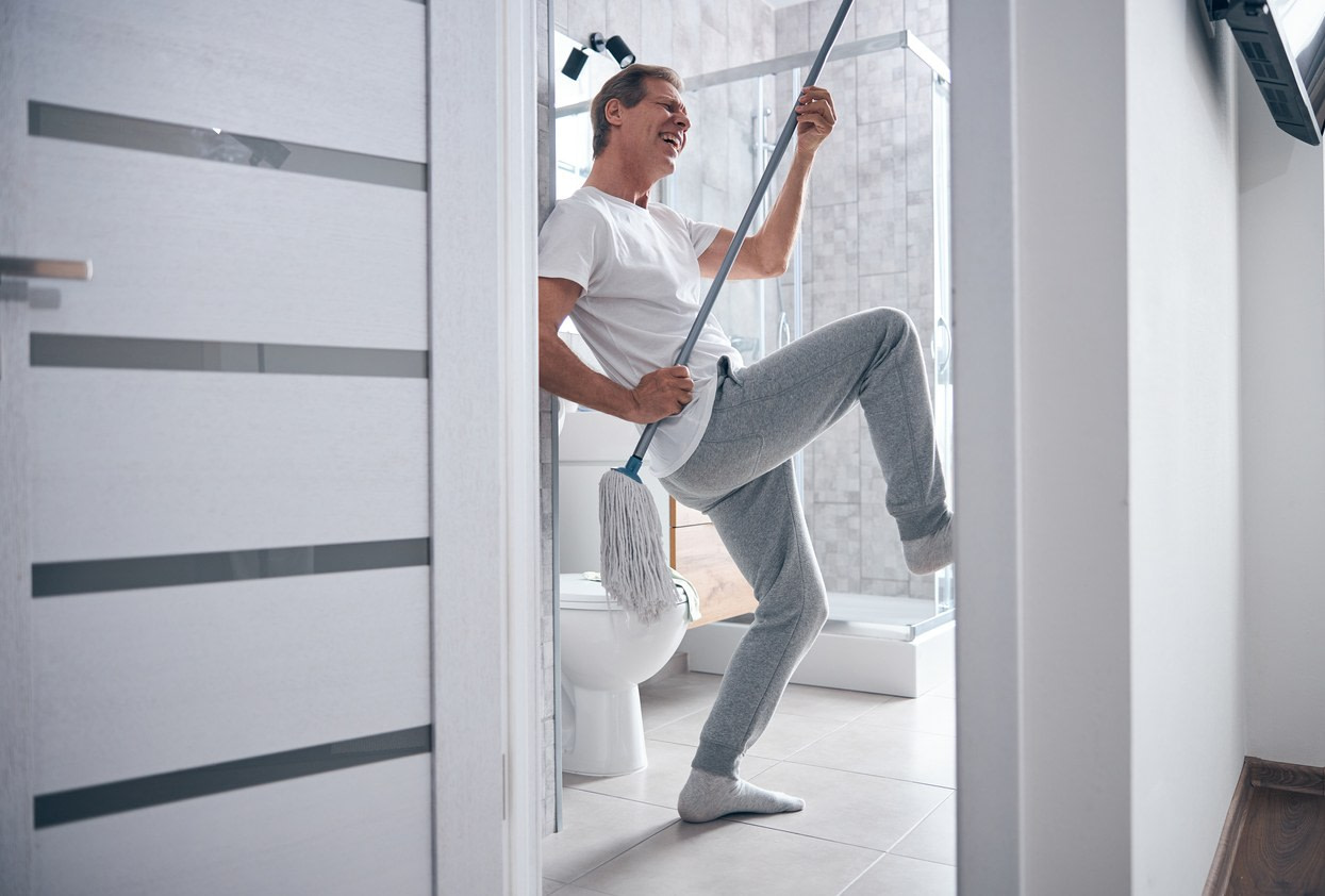 Man rocking out on an air guitar mop