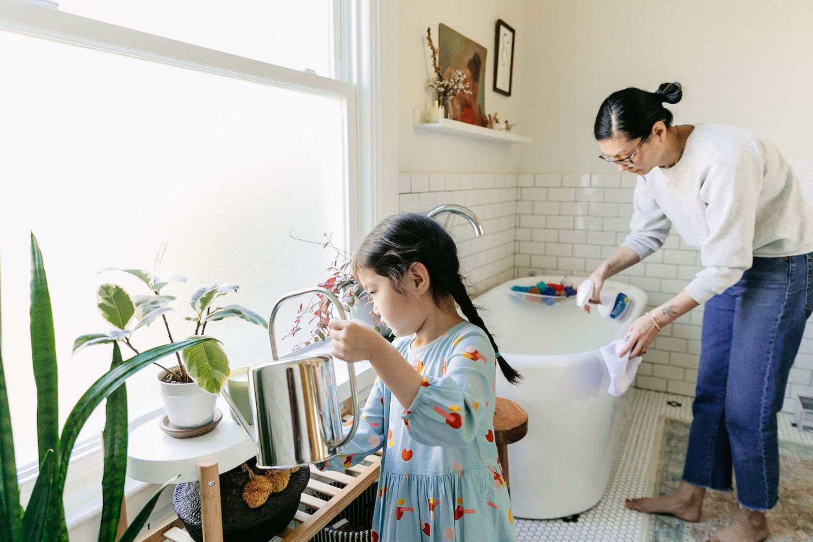 Mother and Daughter Cleaning Bathroom