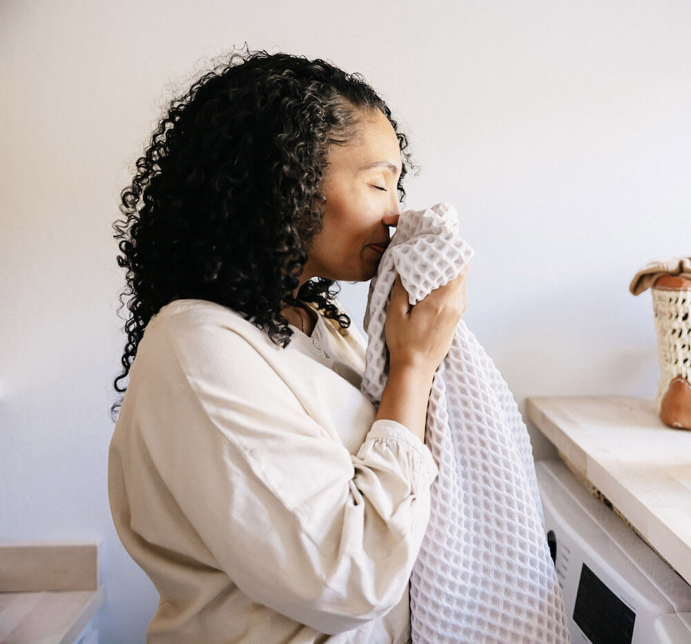 Woman smelling clean laundry