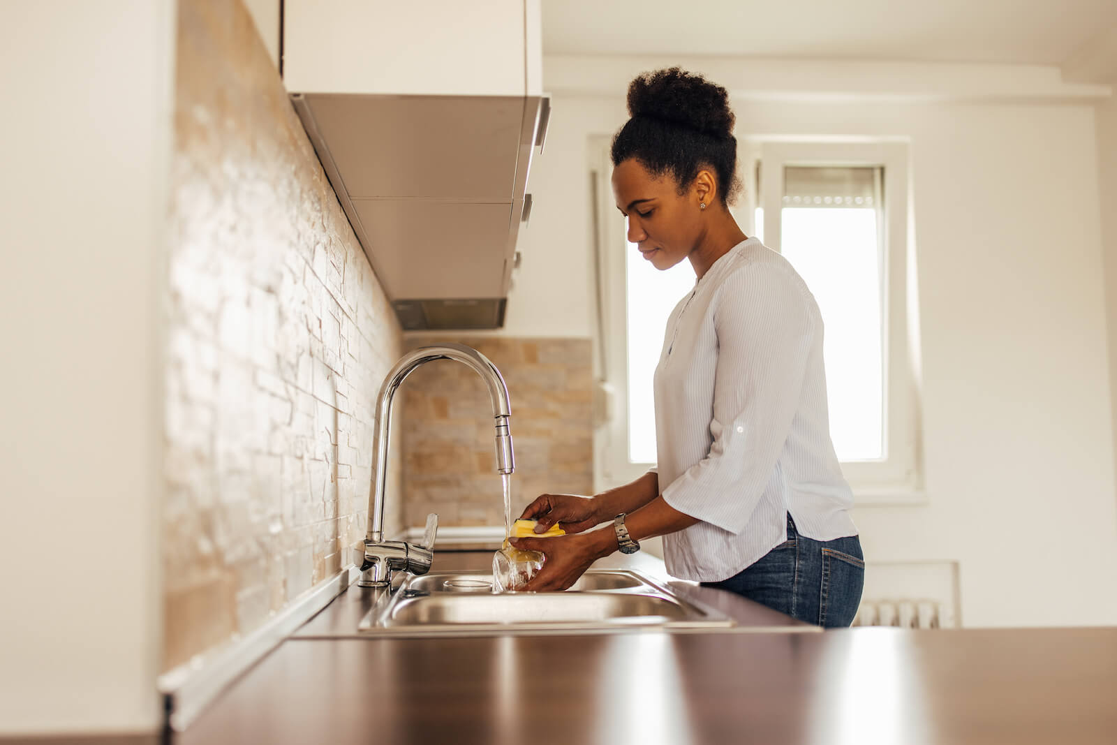 Woman Cleaning At Sink